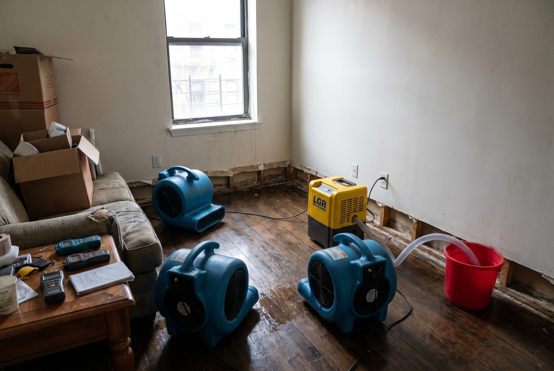 Air movers and a dehumidifier drying a property